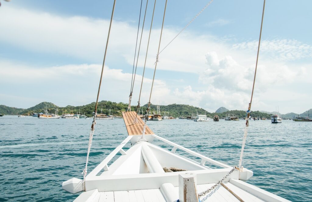 View from Akassa Cruise's bow across the anchorage toward Labuan Bajo's hills