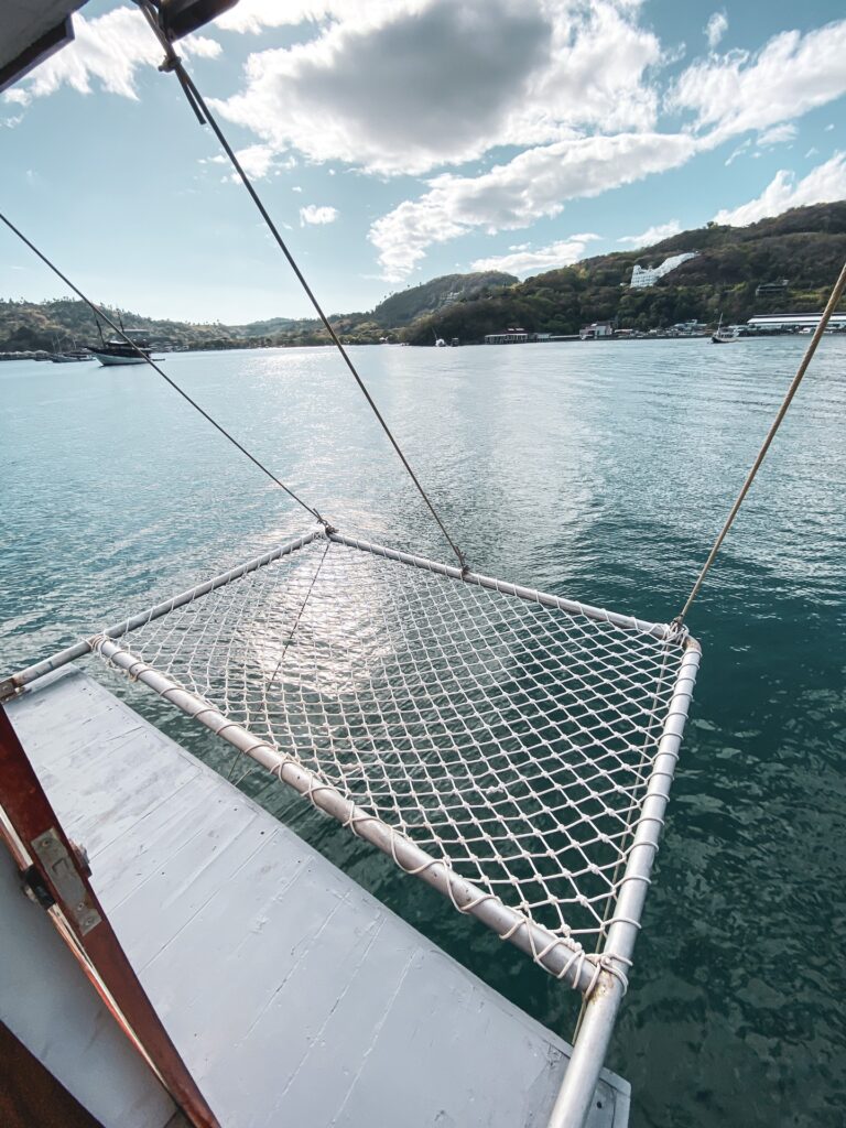 Overwater netting trampoline extending from Amalfi's bow across the harbor