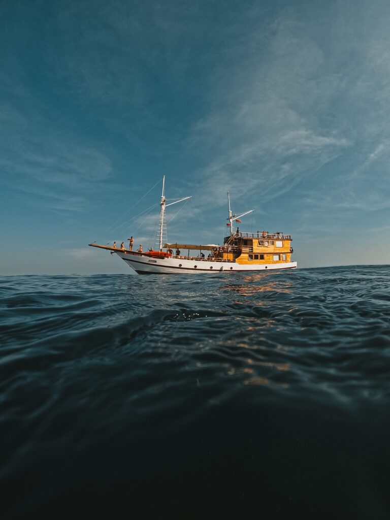 Andalucia phinisi sailing at water level in soft evening light