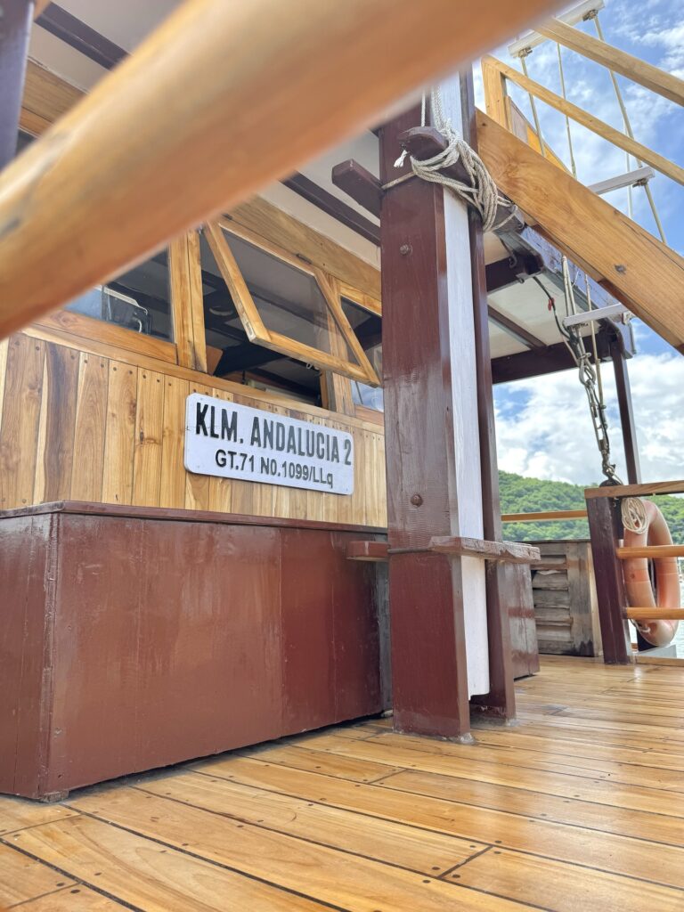 Andalucia's wooden nameplate reading KLM Andalucia 2 mounted on the deck