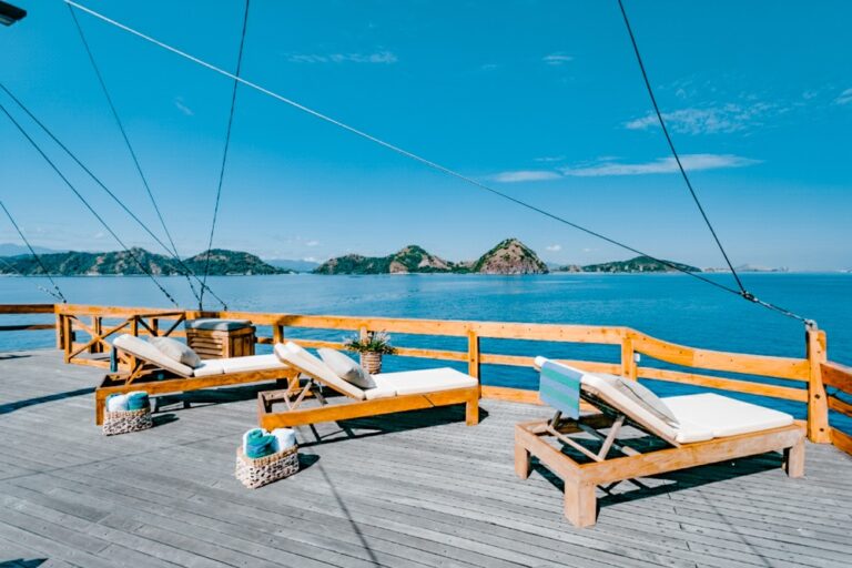 Wooden sun loungers on Andamari's deck with rigging ropes overhead