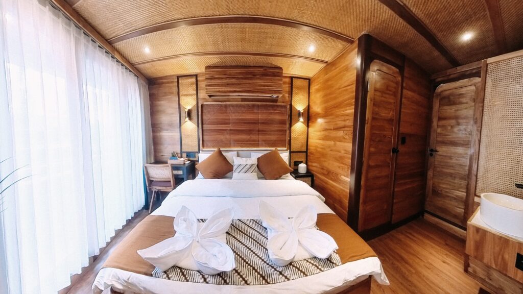 Angelica master suite bed beneath a woven ceiling with wood cabinetry