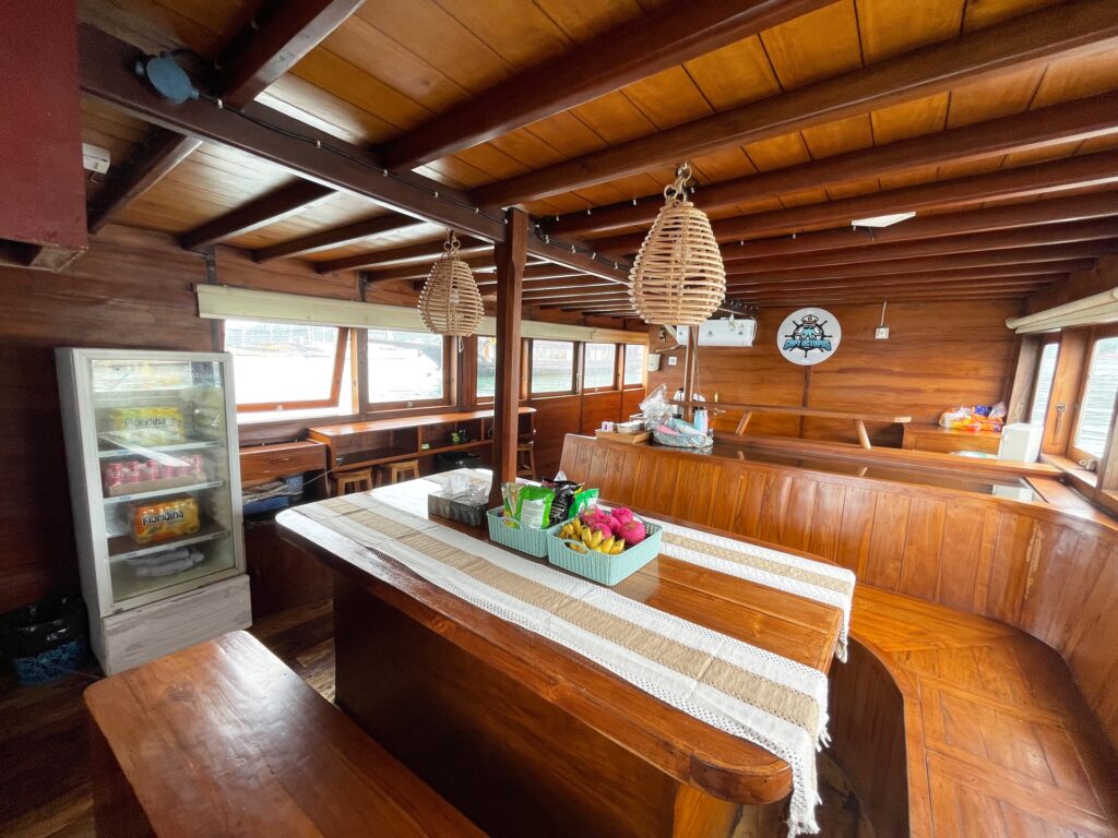 Capt Octopus komodo liveaboard indoor saloon set with a fresh fruit platter