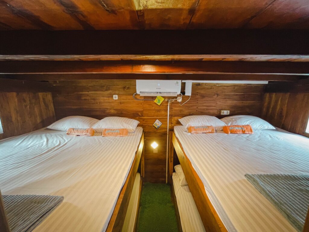 Capt Octopus cabin with two upper bunk beds and striped bedding