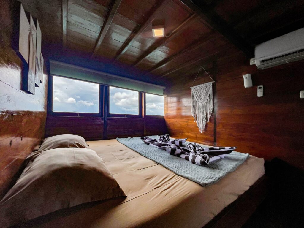 Capt Octopus owners cabin bed beneath wide ocean-view windows