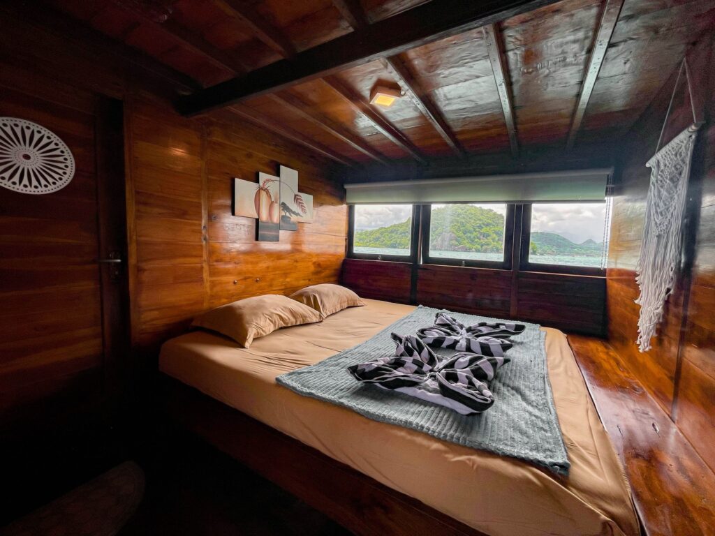 Cabin bed with framed photo art and a mountain-view window
