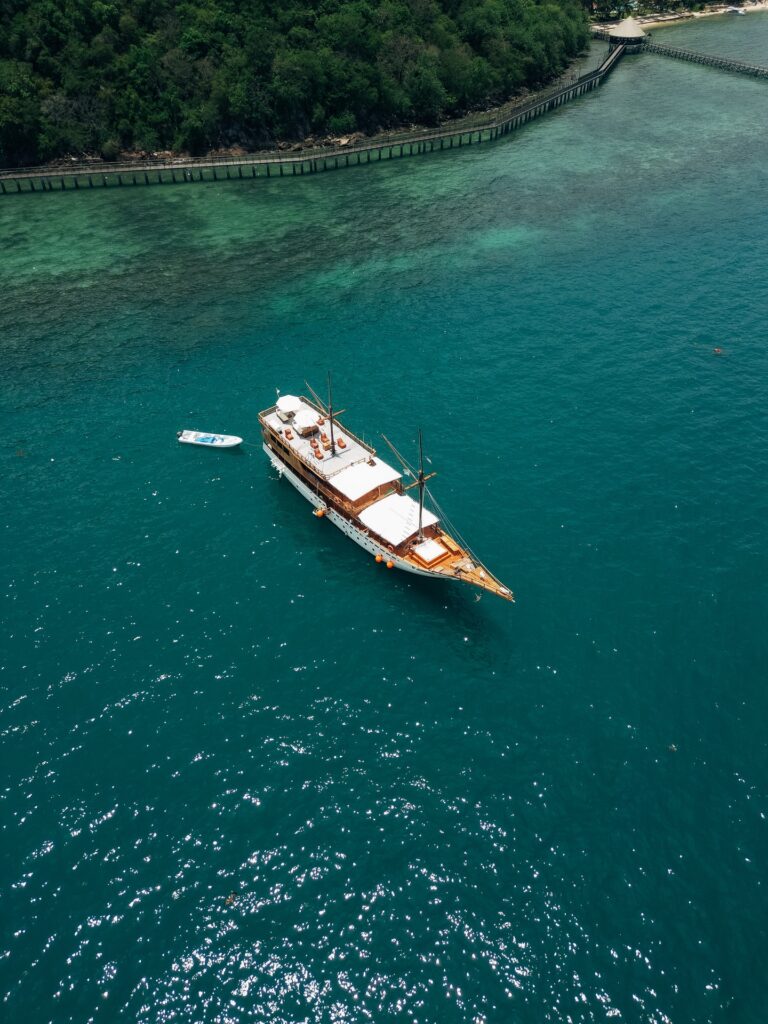 Aerial view of the Carnaby II anchored in turquoise water near the shore