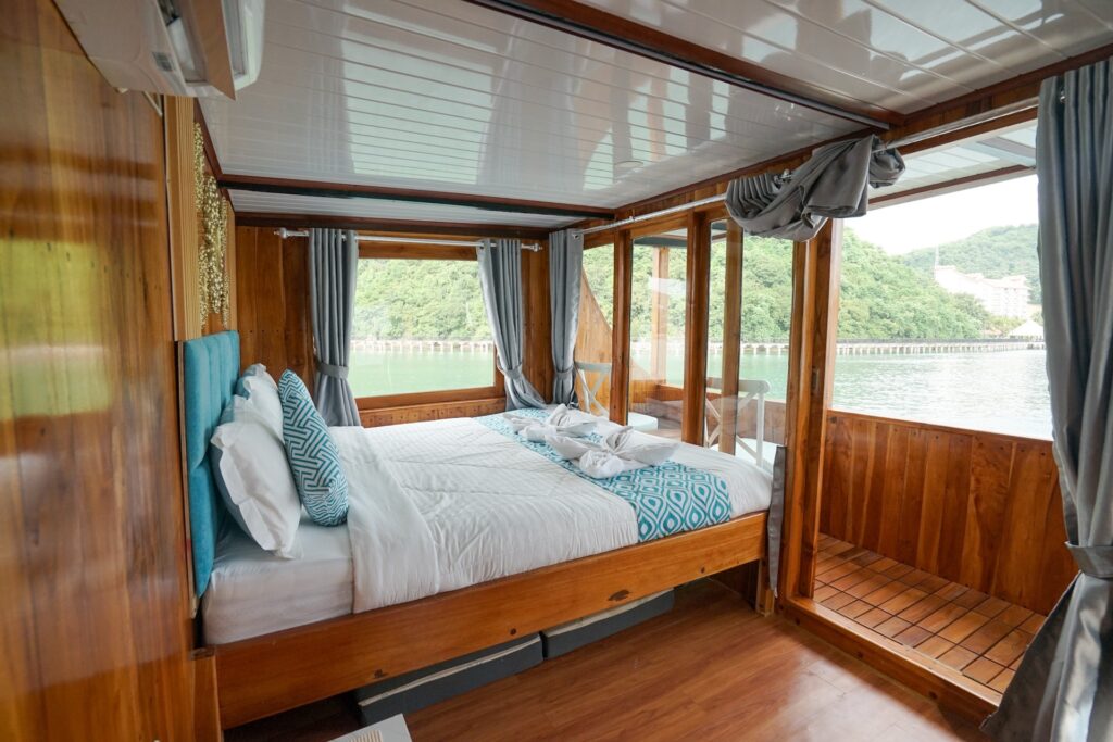 Carnaby I master bedroom with a teal headboard and panoramic windows