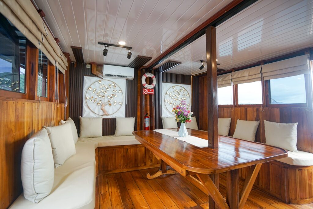 Indoor dining salon with a wood table and cream cushioned bench seating