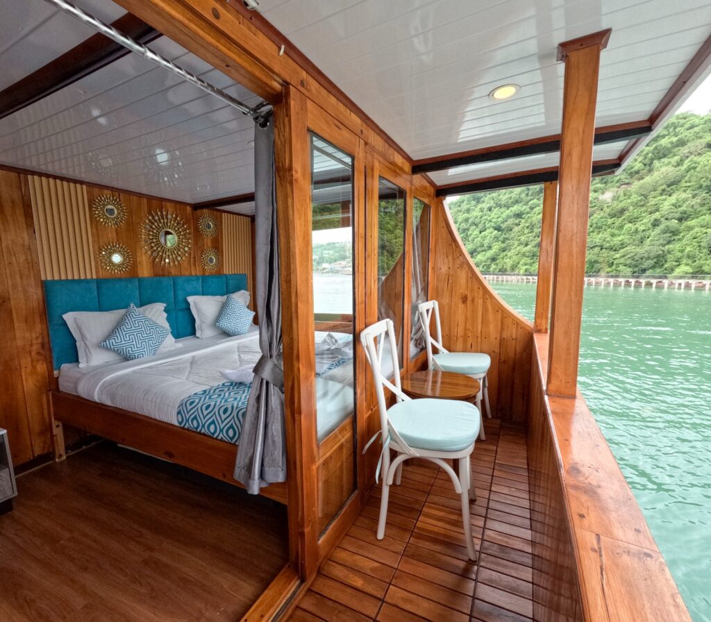 Carnaby I master bed with a teal headboard opening onto a balcony