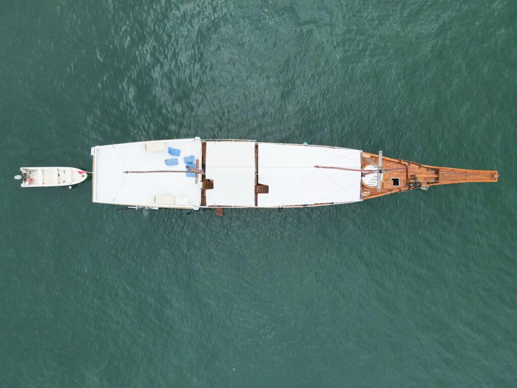 Top-down drone view of Carnaby I with a small tender alongside