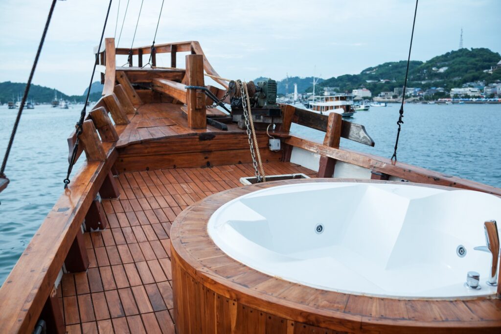 Carnaby I's deck jacuzzi with a wide harbor view and boats in the distance
