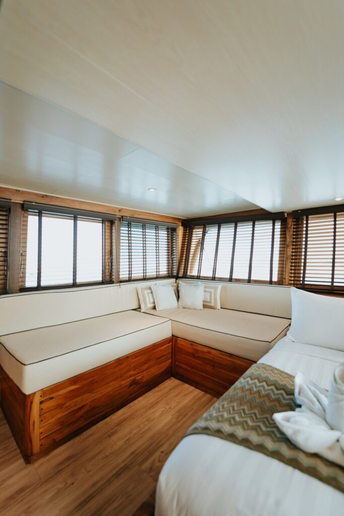Cordelia phinisi suite lounge sofa beside large windows and a corner bed