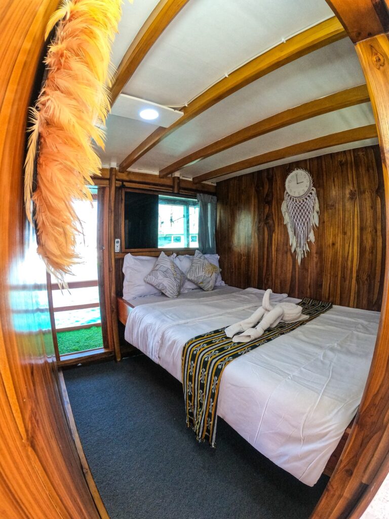 Master suite bed with an ikat runner and a white macrame dreamcatcher on the wall