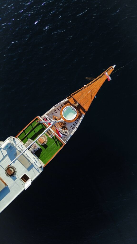 Top down drone shot of the Dinara bow with a round jacuzzi and artificial turf