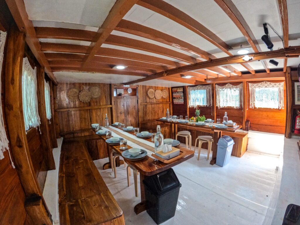 Main salon and dining area on the Dinara set for a group meal