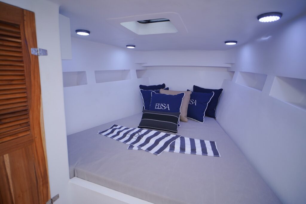 Elisa speedboat cozy rest cabin with striped mattress and navy pillows
