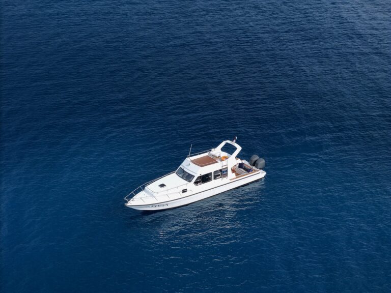 Aerial view of the Elisa speedboat cruising solo across dark blue water