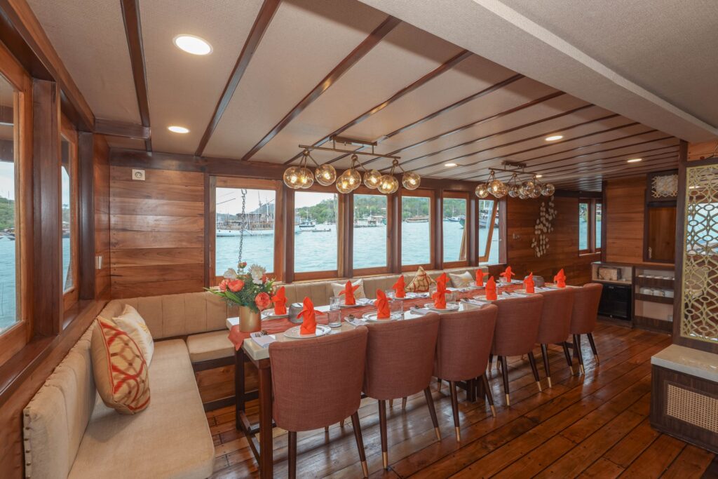 Dining table with modern globe pendant lights inside an air conditioned saloon
