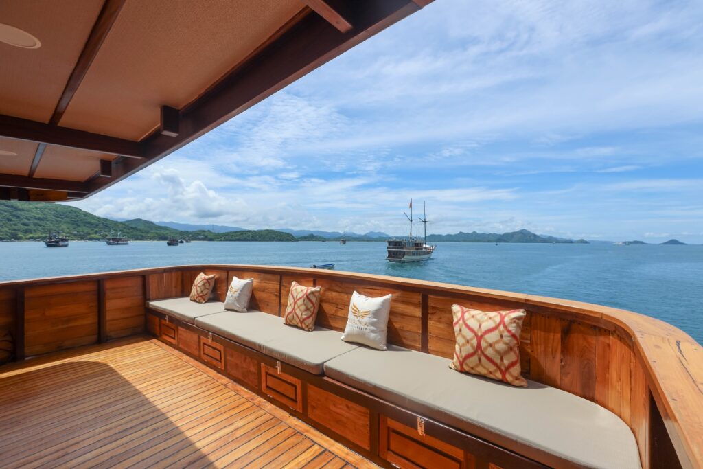 Elrora stern deck bench seating with patterned pillows and ocean views