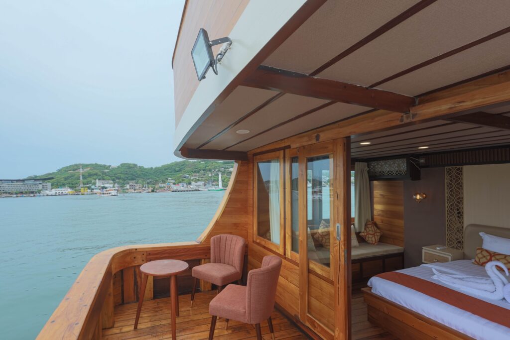 Elrora master cabin private balcony with two chairs and a small table