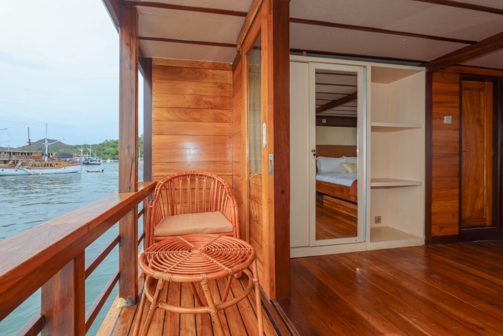 Elrora master suite private balcony with a woven rattan chair