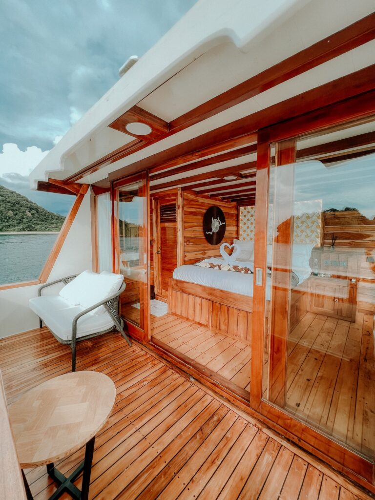 Private balcony deck on the Gandiva with a chair and ocean view
