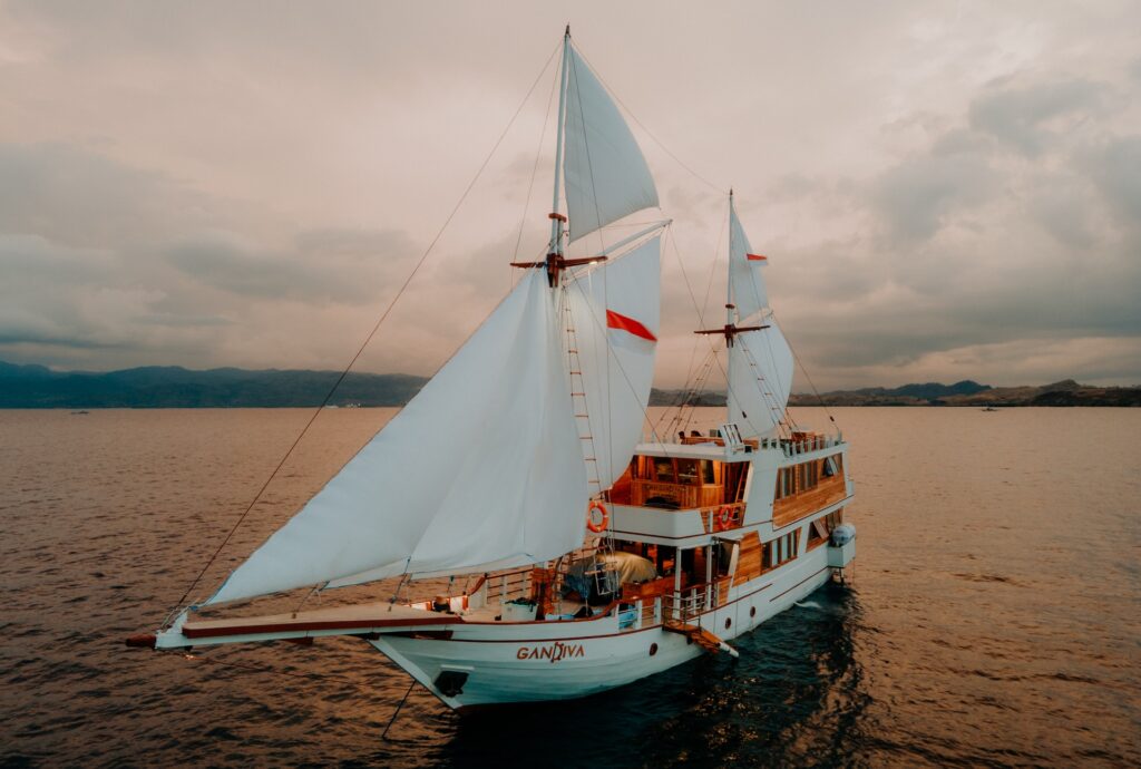 The Gandiva under full sail against a moody overcast sky