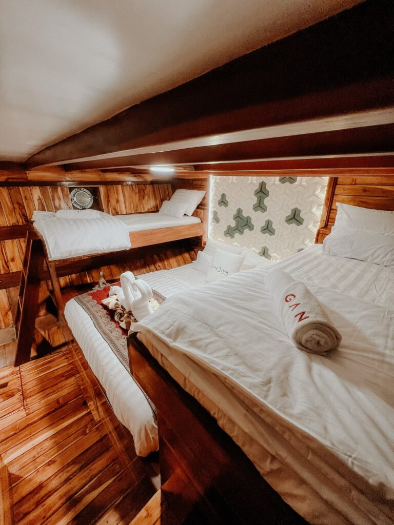 A multi-bed cabin with bunk and double beds and a patterned headboard