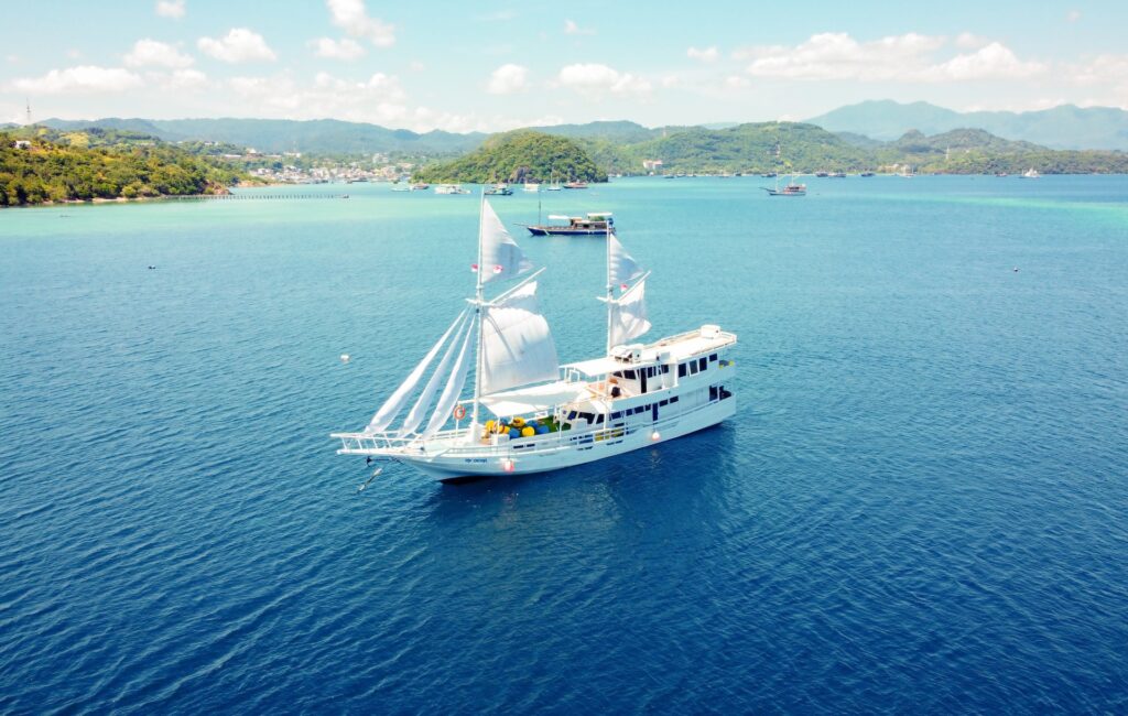Giona komodo liveaboard under full sail near Bidadari Island