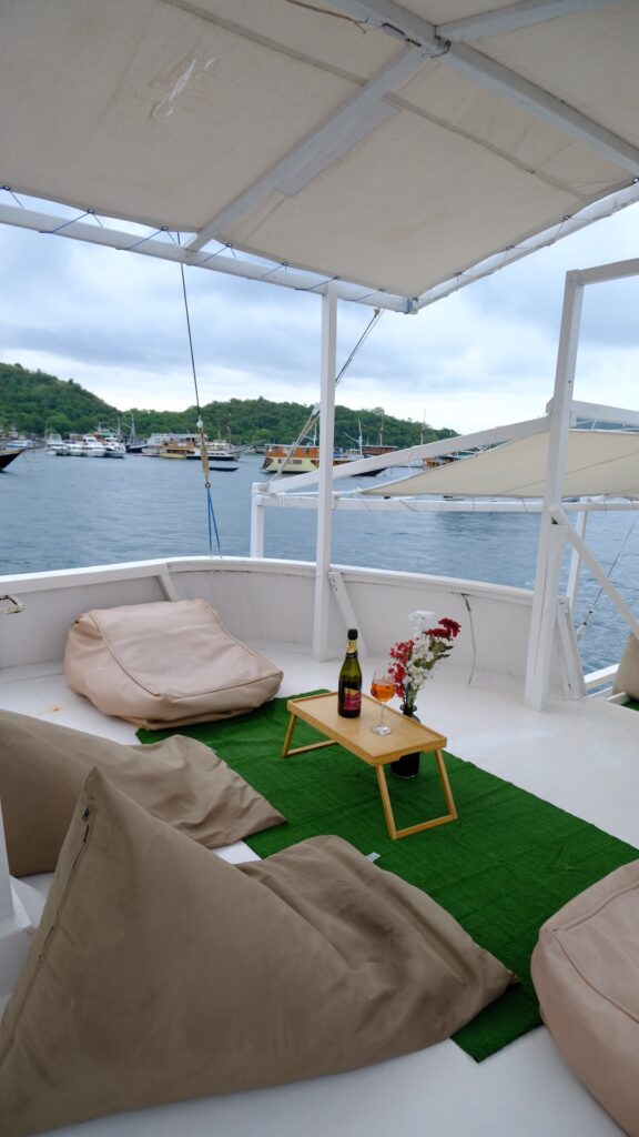 Beanbag seating on the Giona green turf deck with wine and flowers