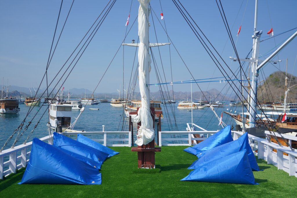 Upper deck with blue beanbags on green turf overlooking the harbor