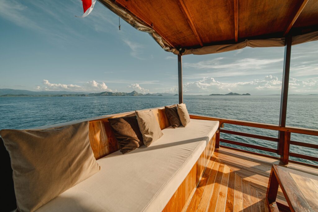 Cushioned outdoor seating on deck overlooking the calm waters of Pink Beach