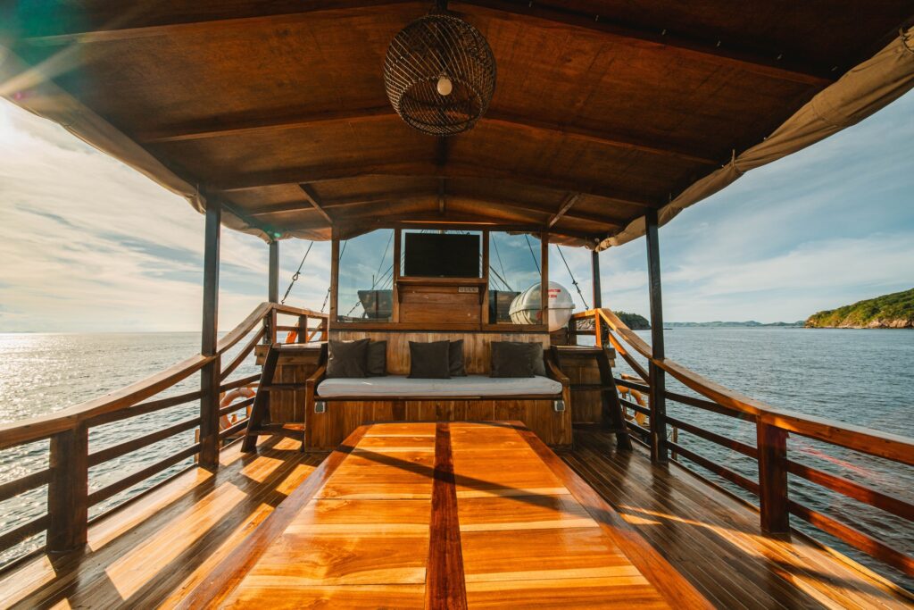 Deck entertainment area with a TV screen and lounge bench at golden hour