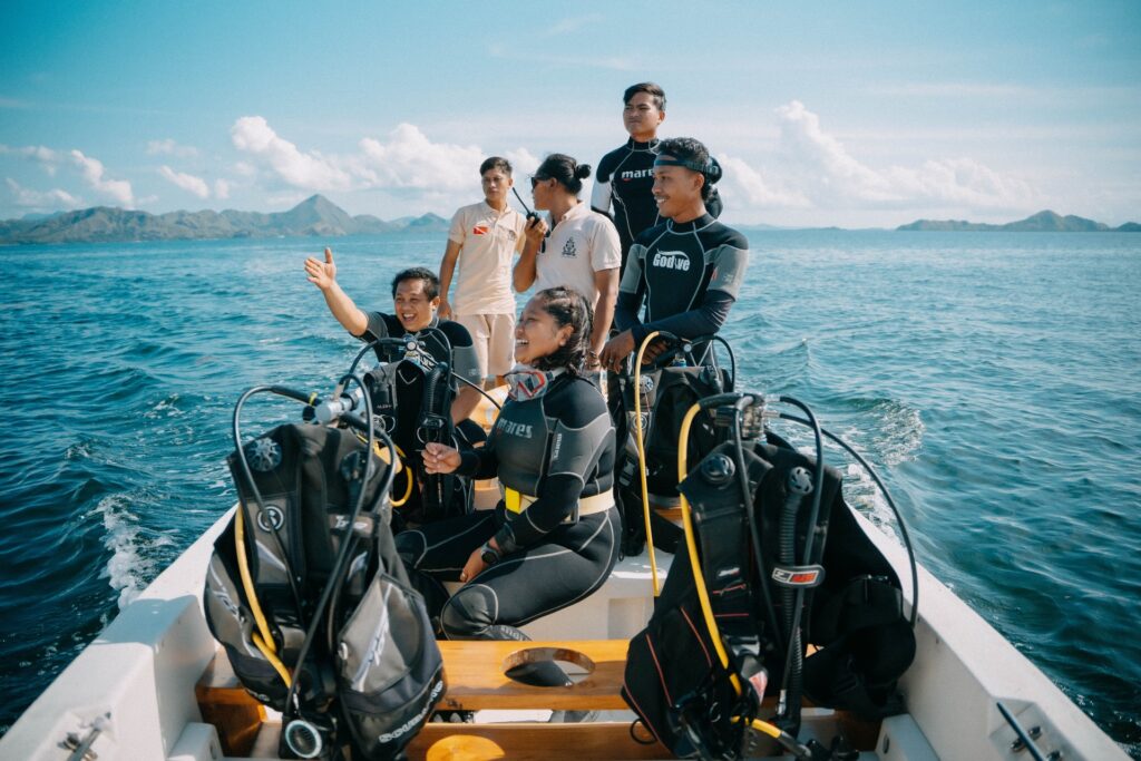 Divers preparing gear on a tender near Batu Bolong dive site