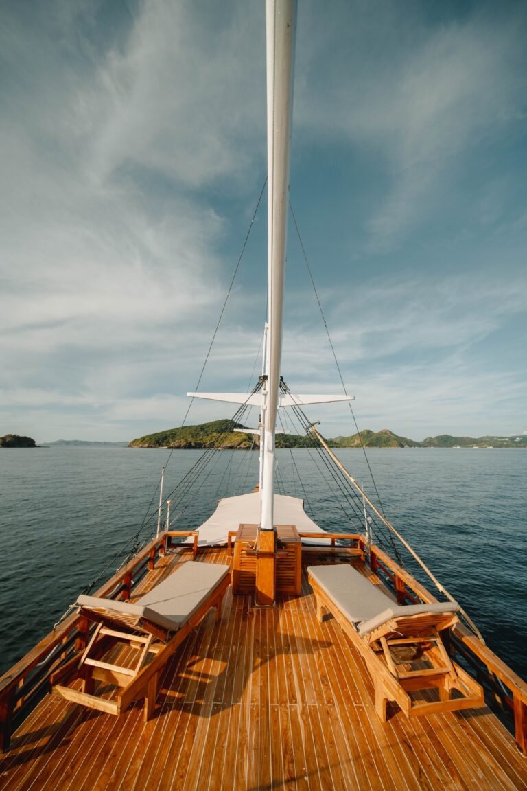 Two wooden sun loungers on the Jofiel bow deck facing open water