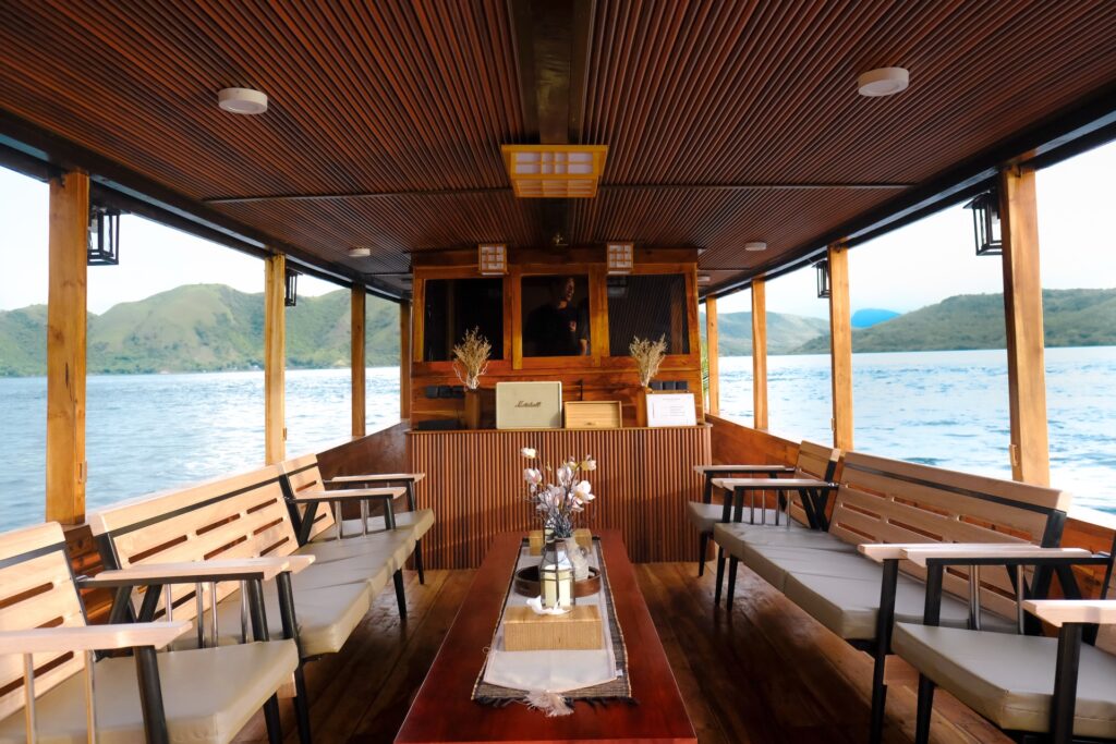 Open deck lounge on the Kimochi with benches on both sides of a long table