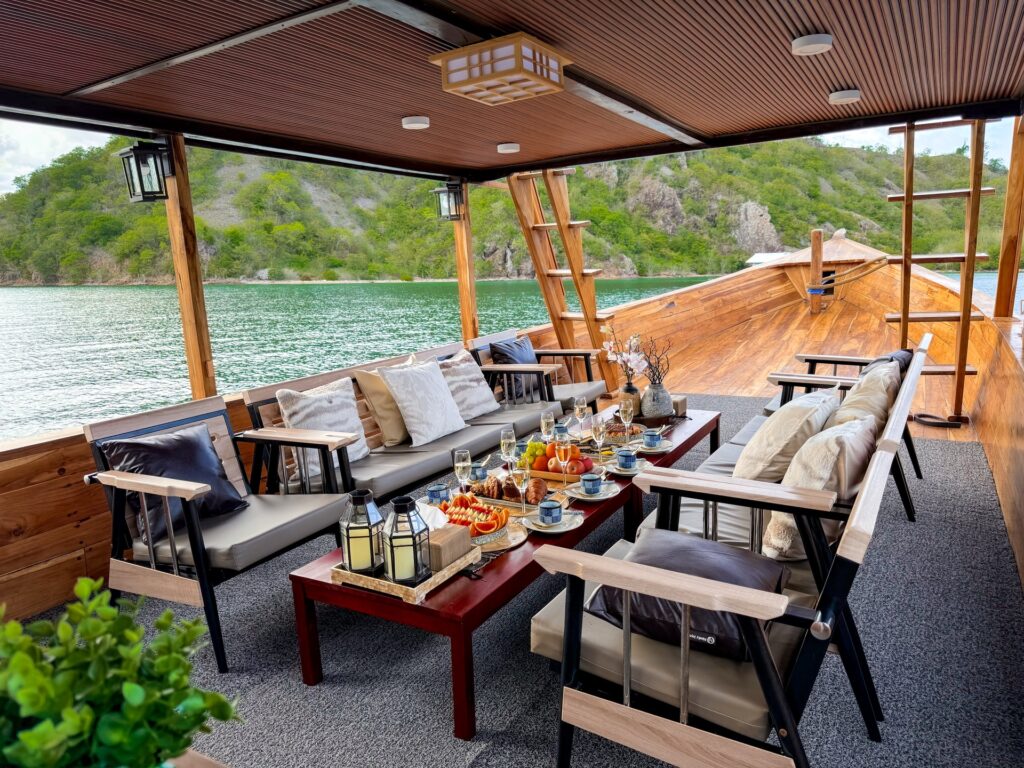 Shaded lounge seating around a low table with drinks and snacks