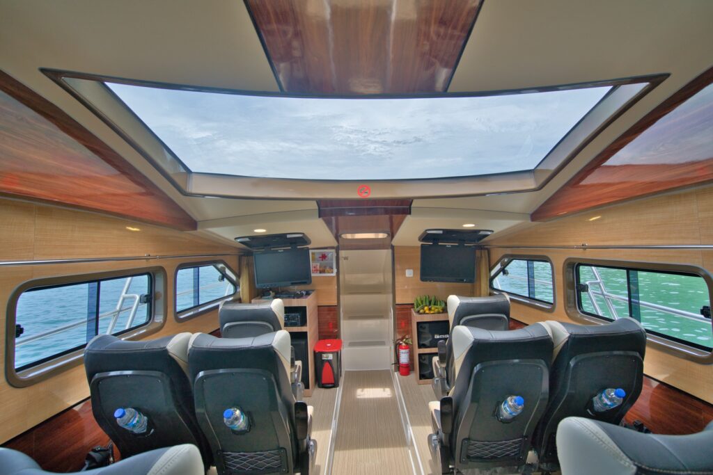 Ocean Queen interior with panoramic skylight, wood trim, and entertainment screens