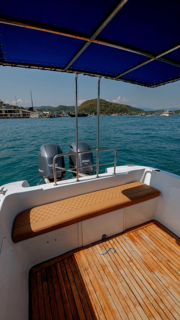 Ocean Manta's shaded aft deck bench with blue canopy overlooking the harbor