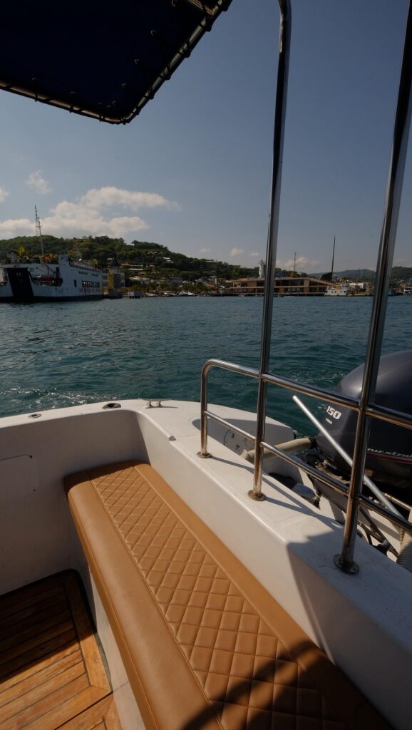 Leather stern bench looking out over the harbor coastline and moored boats