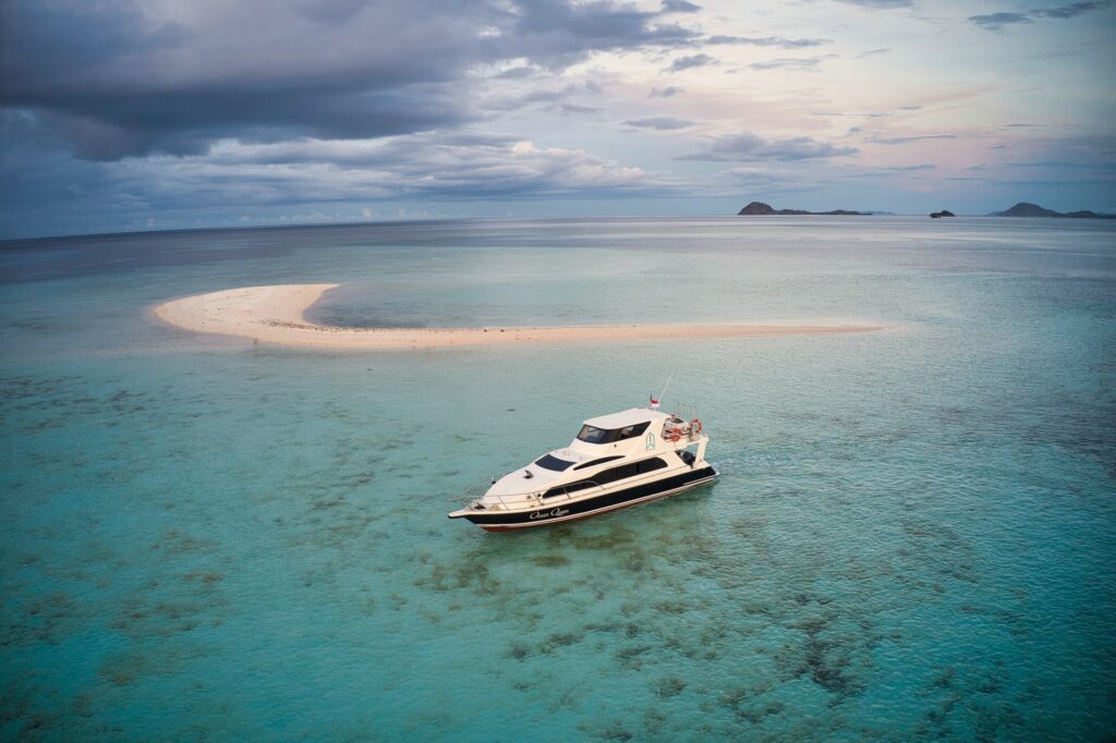 Ocean Queen komodo speedboat day trip anchored beside a shallow sandbar