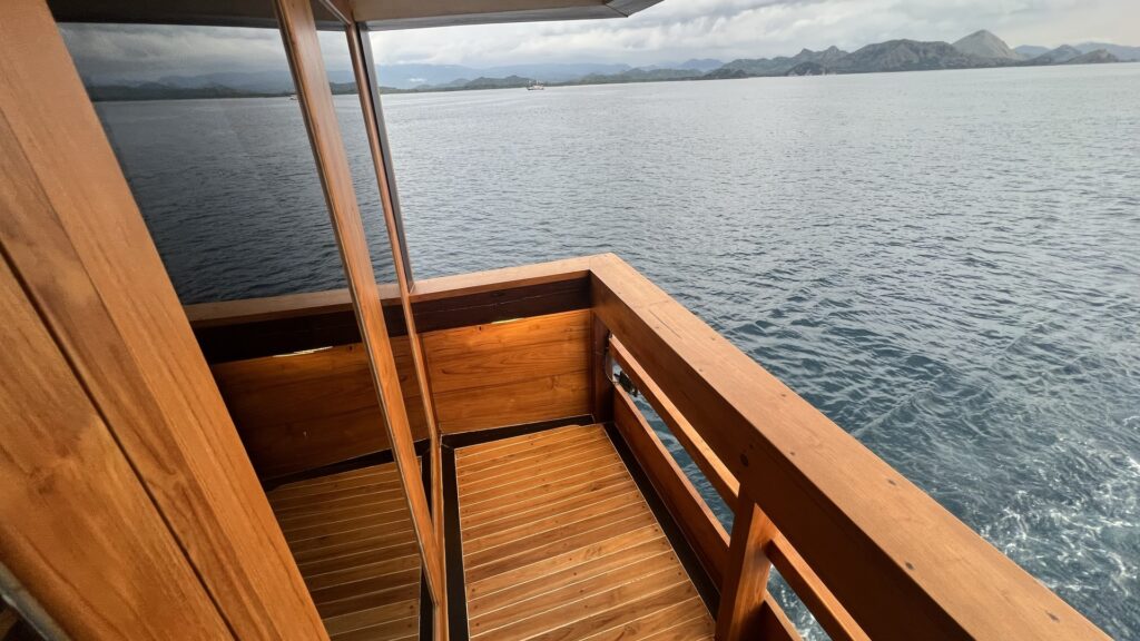 Private wooden balcony deck aboard Panrita overlooking the ocean
