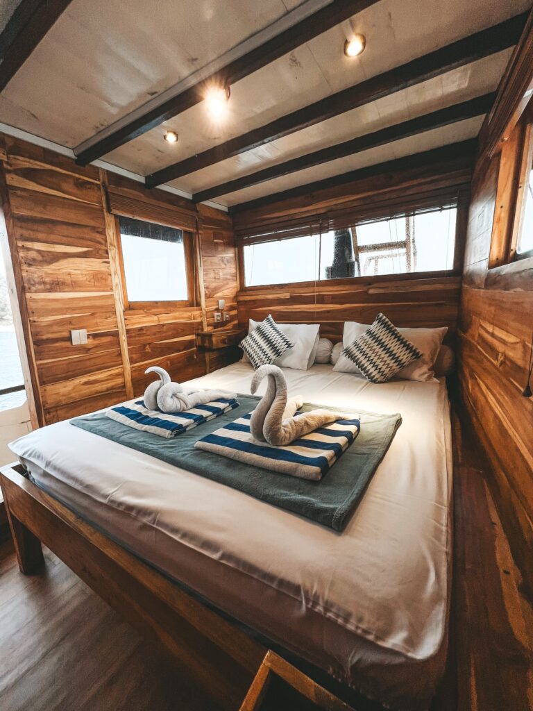 Papiton Lopi queen cabin bed with a swan towel and striped throw blanket