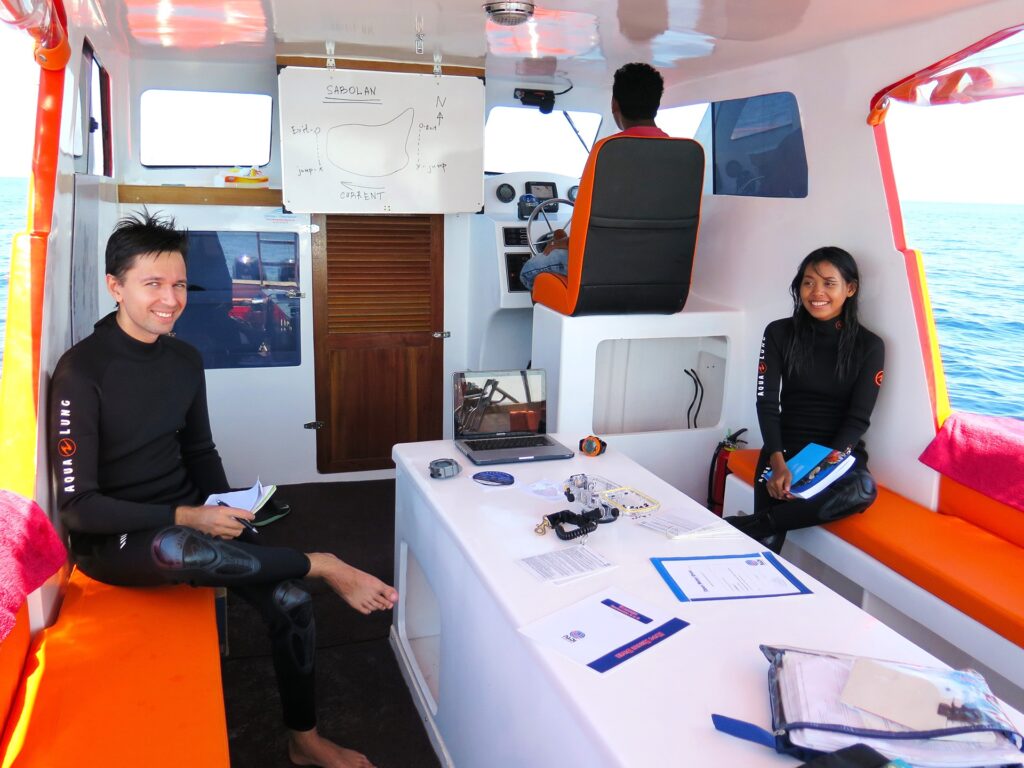 Guests relaxing around the table inside the speedboat's shaded cabin