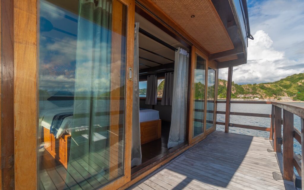 Refviero Master Suite balcony with sliding glass doors opening onto the deck