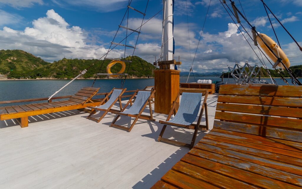 Refviero sun deck lined with wooden lounge chairs and a red life ring