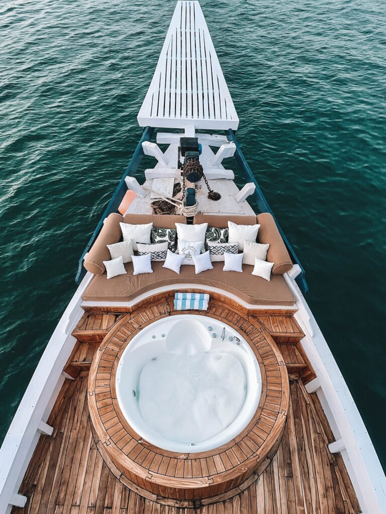 Sea Familia Komodo liveaboard bow deck with round tub and cushioned lounge seating