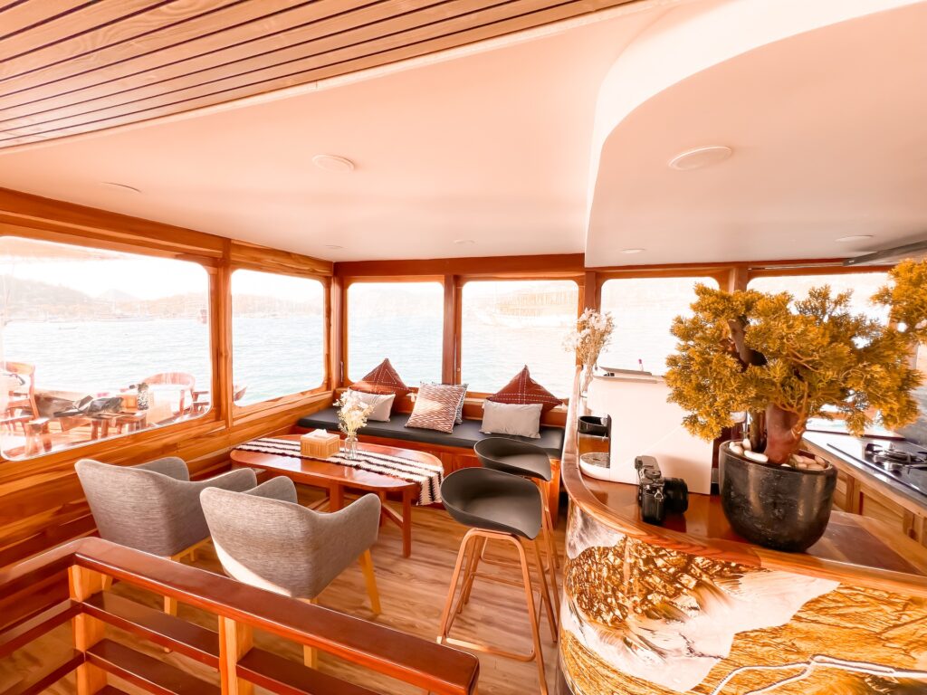 Semesta Voyage's indoor bar lounge with grey armchairs and a marble countertop