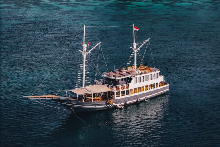 Aerial view of the Semesta Voyage Komodo liveaboard phinisi with twin masts and open sun deck